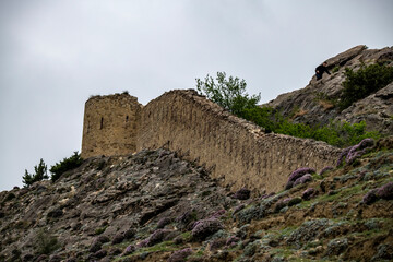 an old dilapidated fortress in the mountains of Dagestan against the backdrop of stunning views of mountains and gorges