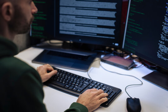 Male programmer working on computer