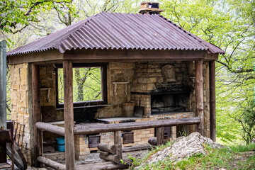 Fototapeta na wymiar outdoor kitchen with stove and barbecue for cooking in the mountains