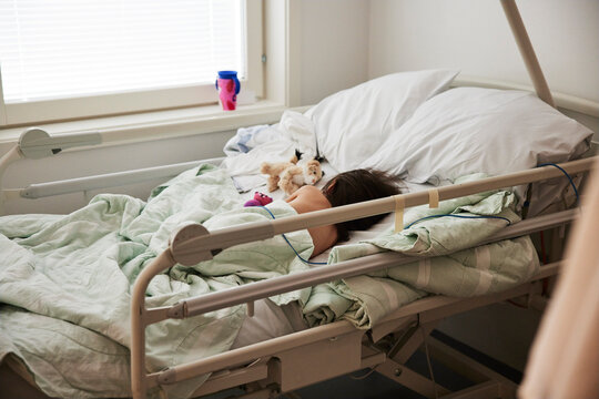 Child sleeping in hospital bed