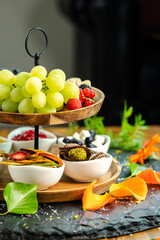 Healthy organic breakfast fruit selection with grapes, strawberry and date sweets