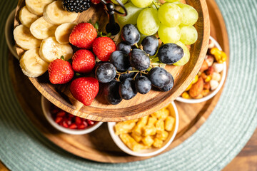 Healthy organic breakfast fruit selection with grapes, strawberry and date sweets