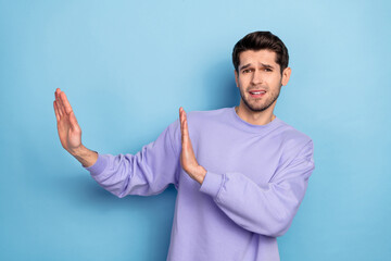 Photo of sad young brunet guy show stop wear sweater isolated on blue color background