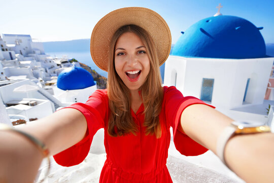 Traveler girl taking a selfie on her vacation in Santorini, Greece