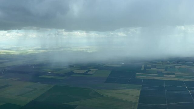 Aerial view of a big rain showers near Seville, Spain, taken from a jet cockpit