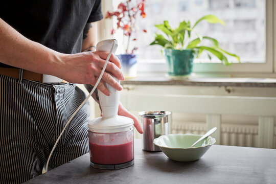 Mid Section Of Man Preparing Food