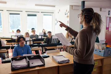 Teenagers attending keyboard lesson