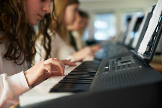 Teenage girl attending keyboard lesson