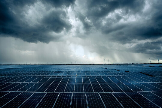 Photovoltaic modules solar power plant on dramatic sky background - Green alternative power energy concept to reduce global warming and climate change