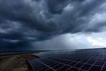 Photovoltaic modules solar power plant on dramatic sky background - Green alternative power energy concept to reduce global warming and climate change