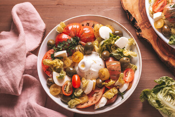 Fresh mediterranean salad with tomatoes and burrata cheese, top view