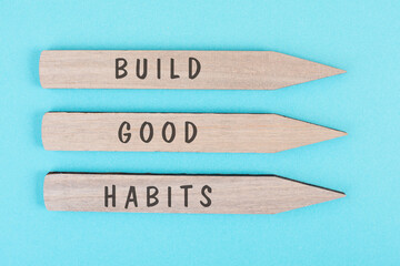 The words build good habits are standing on arrows, change lifestyle, healthy and positive...