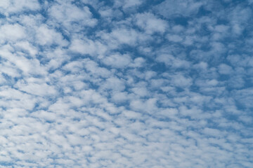 Fototapeta na wymiar Blurred background. Blue sky and white fluffy clouds.