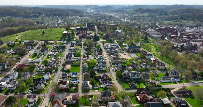 High aerial of city in Appalachian Mountains on sunny day. Aerial truck shot.