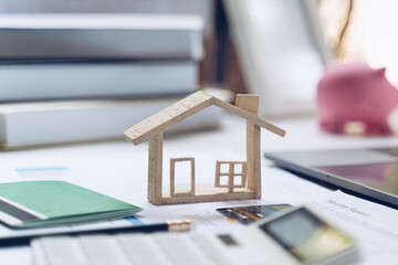 Mockup credit card ,House model, saving account passbook and Notebook on white desk. The concept of...