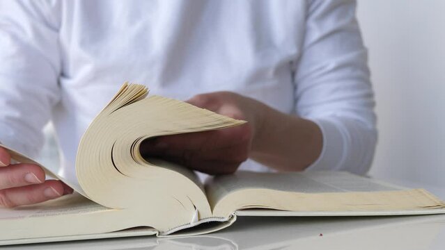 Woman flipping through pages of the bible