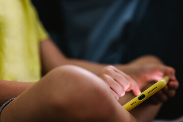 unrecognizable child using the phone