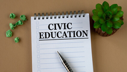 CIVIC EDUCATION - words on a white notebook against the background of a cactus and crumpled papers