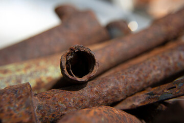 Metal rods. Scrap metal. Color photo of metal surfaces with rust. Diverse old rusty scrap metal from different items close-up. Collection and delivery of scrap metal. Abstract Background