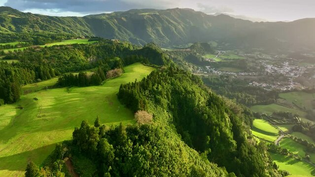 Aerial shot of green meadows and hills of Azores. Classical green landscape at sunset of San Miguel island, Azores, Portugal.