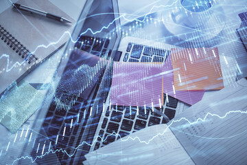 Multi exposure of financial chart drawing over table background with computer. Concept of research and analysis. Top view.