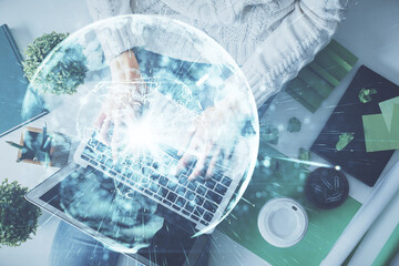 Double exposure of woman hands working on computer and financial theme hologram drawing. Top View. Business concept.