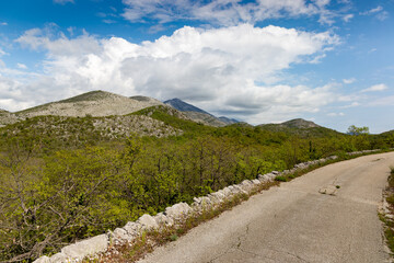 Turist's road based in Konavle region near Dubrovnik. The road along the slope of the mountain above the valley.