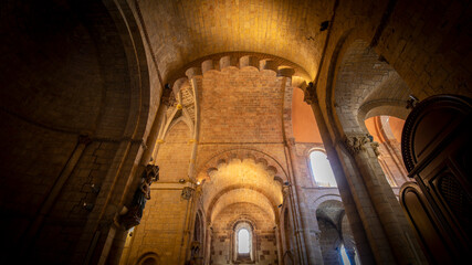 Interior of the Church of San Isidoro de León in Spain in Romanesque style, with overhead lighting and a cozy atmosphere. Architecture, religion, silence and recollection.
