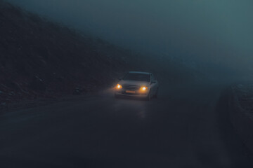 Fototapeta na wymiar Car on the Night Misty Road