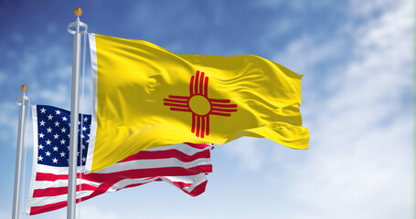 The New Mexico state flag waving along with the national flag of the United States of America