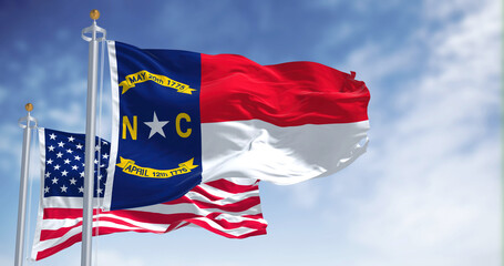 The North Carolina state flag waving along with the national flag of the United States of America