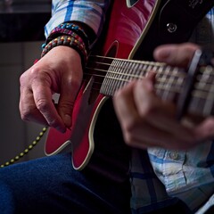 Closeup of hands playing a guitar