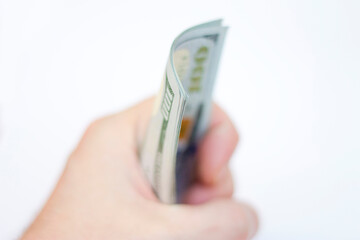 Man ready to exchange pack of Paper Dollars Usa On The White Background