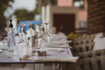 wedding table setting.Table setting in a restaurant. Preparing for a party. Glasses on the table. Preparing for a birthday. Reserved wedding table in summer