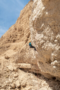 An experienced athlete athlete descends with the equipment for snapping in the mountains of the Judean Desert near the Tamarim stream near Jerusalem in Israel