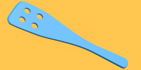 Wooden slotted turner or kitchen utensils on orange background.