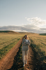 beautiful woman walking on field at sunset