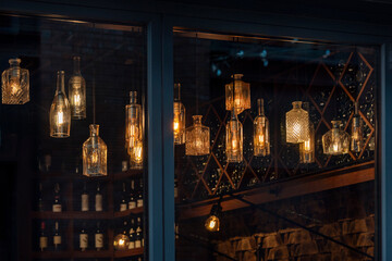 Lanterns made of glass bottles and Edison lamp bulbs. DIY lamps made from recycled old bottles...