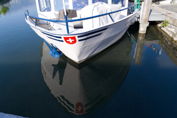 Port at City of Rapperswil with close-up of bow of passenger ship with Swiss coat of arms on a sunny spring morning. Photo taken April 28th, 2022, Rapperswil, Switzerland.