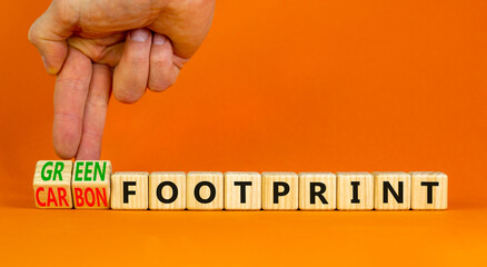 Green or carbon footprint symbol. Businessman turns cubes and changes words Carbon footprint to...