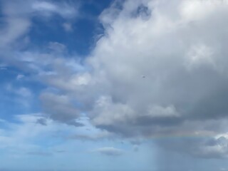 Fototapeta na wymiar Long rainbow with dramatic clouds over the waikiki beach oahu Island, Hawaii year 2022