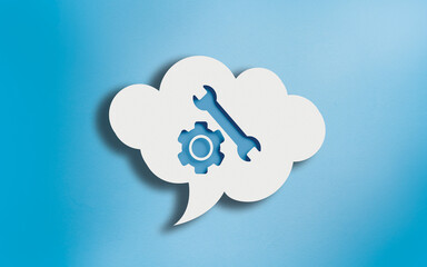 Gear and Wrench Icon in White Cloud Speech Bubble on Blue