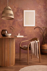 Stylish boho vintage dining room interior with poster mock up. Round table with rattan chair, vase...