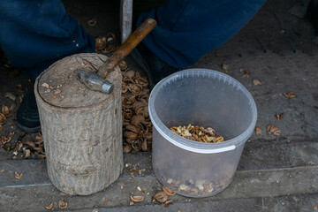 Nuts. Walnut kernels and whole walnuts. Walnuts organic. Top view. Walnut healthy food. break walnuts with hammer on wood. photo series