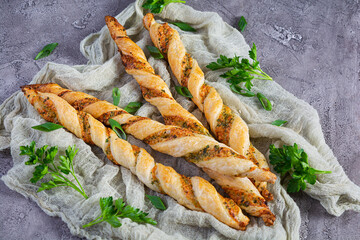 Puff sticks with cheese and herbs. Homemade breadsticks with sauce