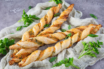 Puff sticks with cheese and herbs. Homemade breadsticks with sauce