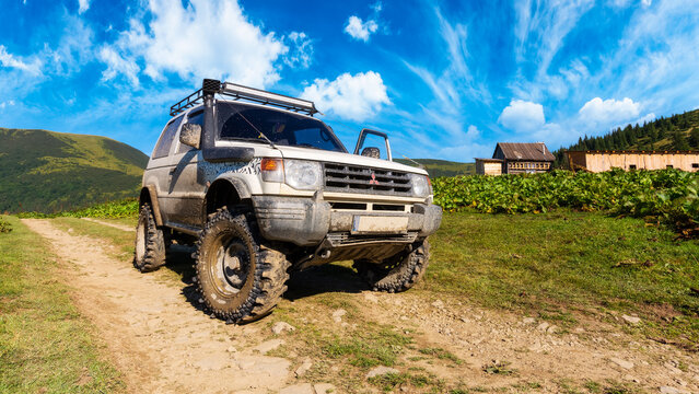 kvasy, ukraine - AUG 22, 2020: off road ready 3 door mitsubishi pajero on the hill. dirty 4x4 vehicle with snorkel and mud tires. stunning adventures on a sunny summer day in mountains