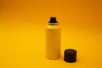 Yellow bottle stands on a yellow background