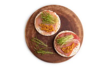 Puffed rice cake sandwiches with jerky salted meat, carrot microgreen isolated on white, top view, close up.