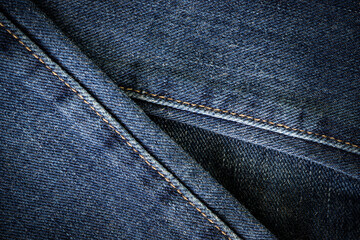 Fashion jeans. Denim fabric. Black jeans background.